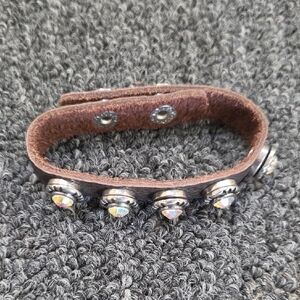 brown leather wrap cuff bracelet featuring iridescent rhinestone studs arranged